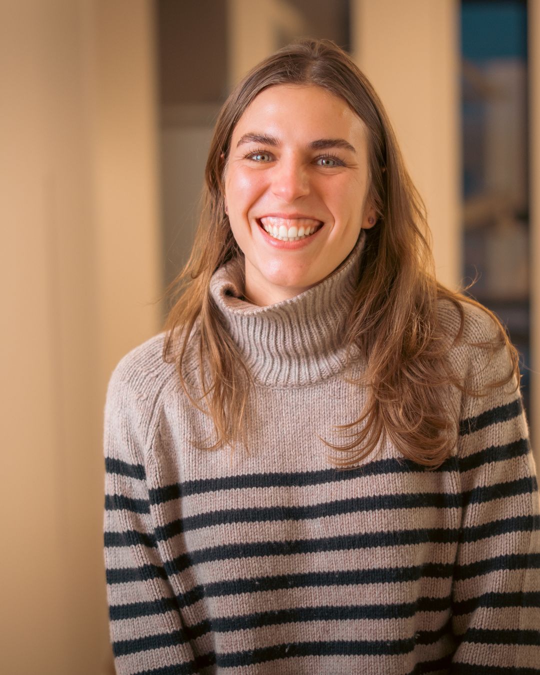 Lächelnde Mitarbeiterin der Zahnarztpraxis Chiemgau Lacht im Praxisflur